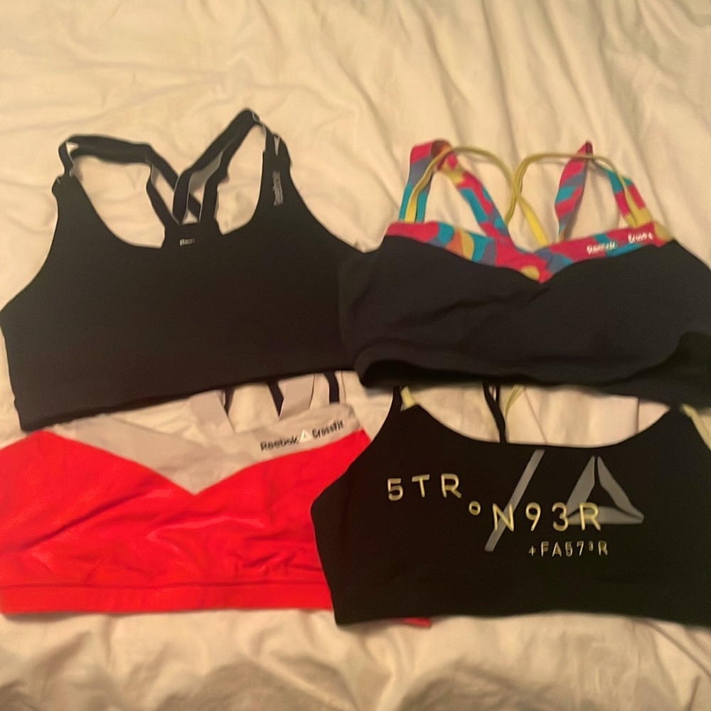 Four gently used Reebok sports bras. 3 size L, 1 M.